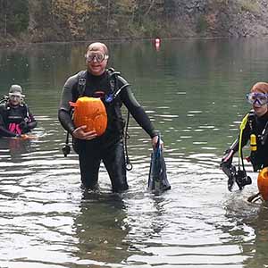 The divers surface, bearing the spoils of their craft
